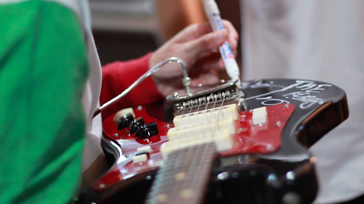 Zaac signing guitar